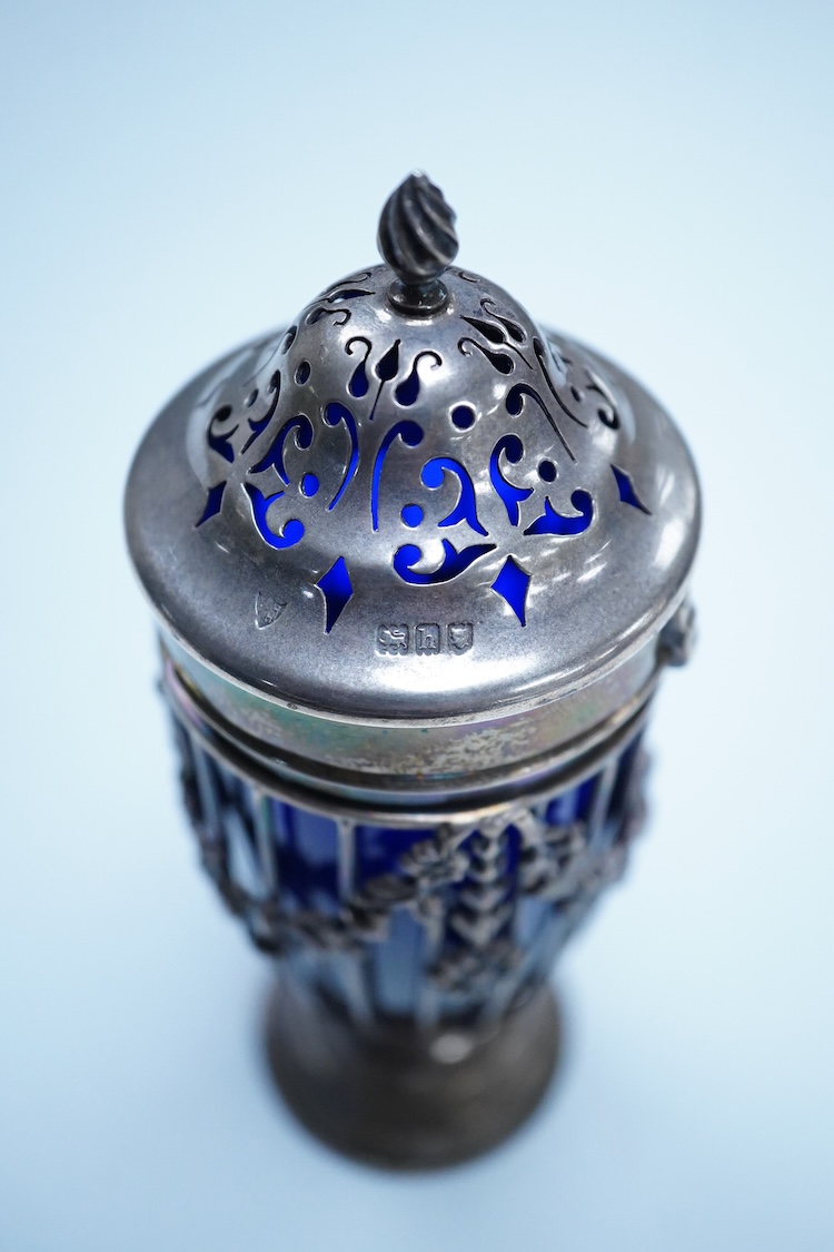 An Edwardian pierced silver sugar caster, with blue glass liner, Haseler Brothers, London, 1903, height 14.3cm.